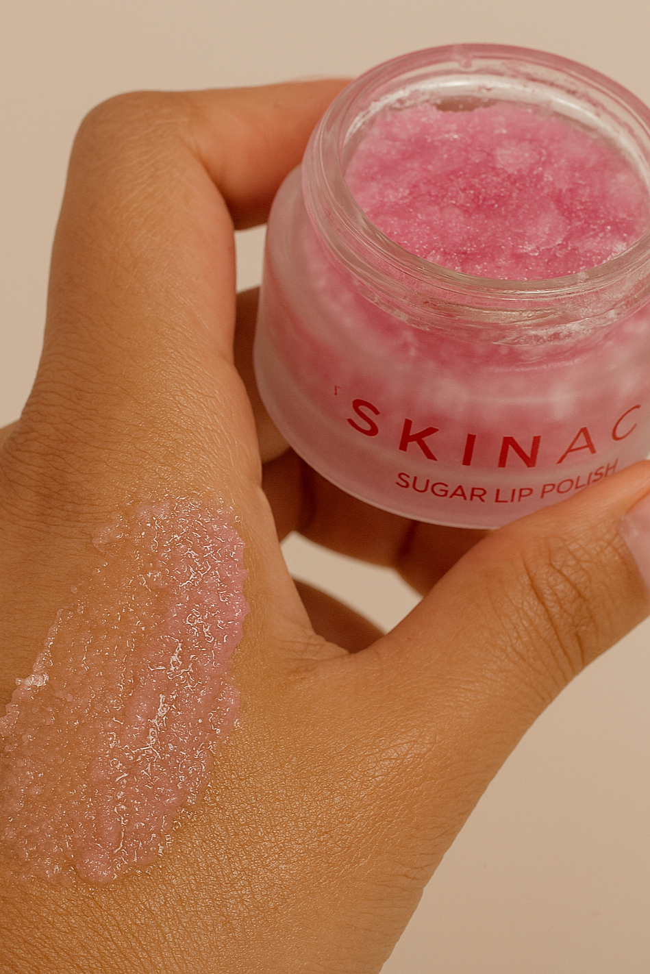 Applying Skinacy Bubblegum Sugar Lip Polish Scrub to hand to show texture